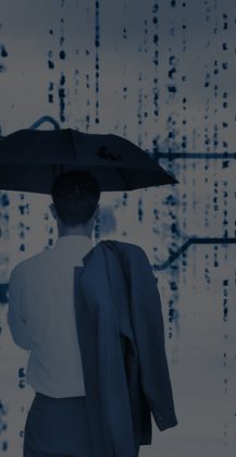 Businessman with an umbrella looking at a giant key with blue sky on the background Businessman with an umbrella looking at a giant key with blue sky on the background